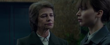 Movie still from “Red Sparrow” (2018), directed by Francis Lawrence – An older woman wearing a suit and a tie; Close Up shot, Over the shoulder angle