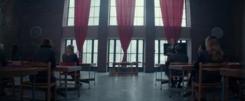 Movie still from “Red Sparrow” (2018), directed by Francis Lawrence – Two people sitting at a table in front of a window; Extreme Wide shot, Low angle