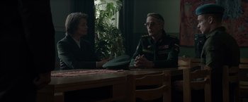 Movie still from “Red Sparrow” (2018), directed by Francis Lawrence – A man and a woman sitting at a wooden table; Medium shot, Over the shoulder angle