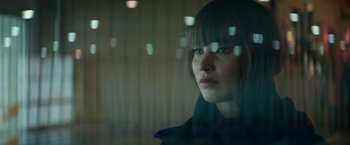 Movie still from “Red Sparrow” (2018), directed by Francis Lawrence – A woman looking out of a window at night; Close Up shot, Over the shoulder angle