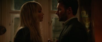 Movie still from “Red Sparrow” (2018), directed by Francis Lawrence – A man and a woman standing next to each other holding drinks; Close Up shot, Over the shoulder angle
