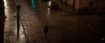 Movie still from “Red Sparrow” (2018), directed by Francis Lawrence – A woman walking down a street at night; Extreme Wide shot, High angle