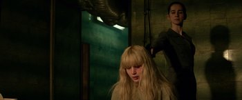 Movie still from “Red Sparrow” (2018), directed by Francis Lawrence – A woman with long blonde hair getting her hair done; Medium shot, Over the shoulder angle