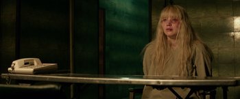 Movie still from “Red Sparrow” (2018), directed by Francis Lawrence – A woman standing in front of a metal railing; Medium shot, Over the shoulder angle