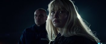 Movie still from “Red Sparrow” (2018), directed by Francis Lawrence – A woman and a man are looking at the camera; Close Up shot, Over the shoulder angle