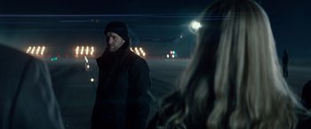 Movie still from “Red Sparrow” (2018), directed by Francis Lawrence – A man and a woman standing in the middle of an airport runway; Close Up shot, Over the shoulder angle