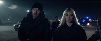 Movie still from “Red Sparrow” (2018), directed by Francis Lawrence – A man and a woman are walking in the dark; Close Up shot, Over the shoulder angle