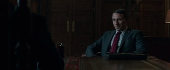 Movie still from “Red Sparrow” (2018), directed by Francis Lawrence – A man sitting at a table in front of a woman; Medium shot, Over the shoulder angle