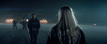 Movie still from “Red Sparrow” (2018), directed by Francis Lawrence – A man and a woman standing in a parking lot at night; Wide shot, Over the shoulder angle