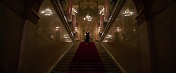 Movie still from “Red Sparrow” (2018), directed by Francis Lawrence – A woman is walking down the stairs of a building; Extreme Wide shot, Low angle