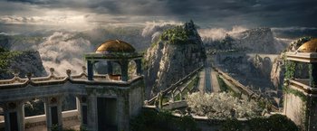Movie still from “The Lord of the Rings: The Rings of Power” (2022), created by Patrick McKay – An image of an outdoor scene with a train going down the tracks; Extreme Wide shot, High angle