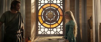 Movie still from “The Lord of the Rings: The Rings of Power” (2022), created by Patrick McKay – A woman standing in front of a stained - glass window; Medium shot, Low angle