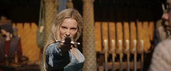 Movie still from “The Lord of the Rings: The Rings of Power” (2022), created by Patrick McKay – A woman holding a pair of chopsticks in her hand; Close Up shot, Over the shoulder angle