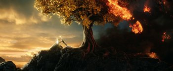 Movie still from “The Lord of the Rings: The Rings of Power” (2022), created by Patrick McKay – An image of an image of a tree that is lit up; Extreme Wide shot, High angle