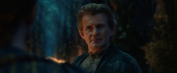 Movie still from “The Lord of the Rings: The Rings of Power” (2022), created by Patrick McKay – A person wearing a suit; Close Up shot, Over the shoulder angle