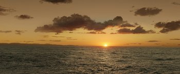Movie still from “The Lord of the Rings: The Rings of Power” (2022), created by Patrick McKay – The sun is setting over the ocean as seen from a boat; Extreme Wide shot, High angle