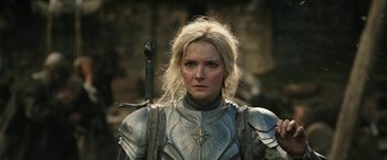 Movie still from “The Lord of the Rings: The Rings of Power” (2022), created by Patrick McKay – A person holding a sword and wearing armor; Close Up shot, Low angle