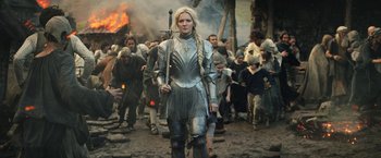 Movie still from “The Lord of the Rings: The Rings of Power” (2022), created by Patrick McKay – A woman dressed as a medieval knight in front of a crowd of onlookers; Medium shot, Low angle