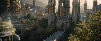 Movie still from “The Lord of the Rings: The Rings of Power” (2022), created by Patrick McKay – An image of a castle in the middle of a forest; Extreme Wide shot, Low angle