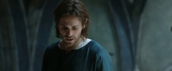 Movie still from “The Lord of the Rings: The Rings of Power” (2022), created by Patrick McKay – A person with long brown hair; Close Up shot, Low angle