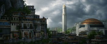 Movie still from “The Lord of the Rings: The Rings of Power” (2022), created by Patrick McKay – A tall clock tower towering over a city; Extreme Wide shot, Low angle