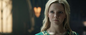 Movie still from “The Lord of the Rings: The Rings of Power” (2022), created by Patrick McKay – A beautiful blonde woman with blue eyes; Close Up shot, Over the shoulder angle