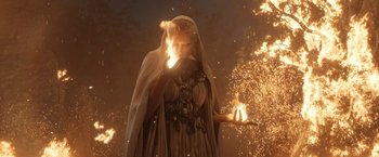 Movie still from “The Lord of the Rings: The Rings of Power” (2022), created by Patrick McKay – A woman in a white dress holding a burning candle; Medium shot, Low angle