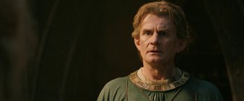 Movie still from “The Lord of the Rings: The Rings of Power” (2022), created by Patrick McKay – A person wearing a necklace; Close Up shot, Low angle