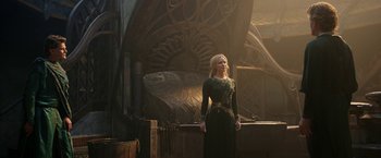 Movie still from “The Lord of the Rings: The Rings of Power” (2022), created by Patrick McKay – A woman standing in front of an ornate building; Wide shot, Low angle