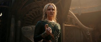 Movie still from “The Lord of the Rings: The Rings of Power” (2022), created by Patrick McKay – A woman in a green dress holding a sword in her hand; Medium shot, Low angle