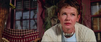 Movie still from “The Lost Boys” (1987), directed by Joel Schumacher – A person sitting in a room; Close Up shot, Low angle