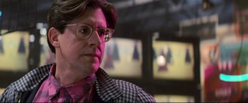 Movie still from “The Lost Boys” (1987), directed by Joel Schumacher – A man wearing glasses and a checkered jacket; Close Up shot, Over the shoulder angle
