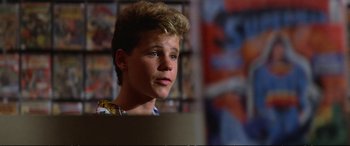 Movie still from “The Lost Boys” (1987), directed by Joel Schumacher – A young man with blonde hair looking to his left; Close Up shot, Low angle