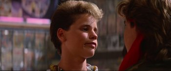Movie still from “The Lost Boys” (1987), directed by Joel Schumacher – A young man with a mohawk haircut looks upward; Close Up shot, Low angle