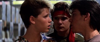 Movie still from “The Lost Boys” (1987), directed by Joel Schumacher – A group of young men standing next to each other; Close Up shot, Over the shoulder angle