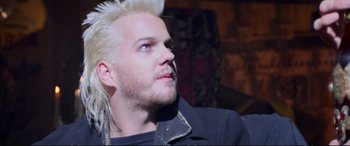 Movie still from “The Lost Boys” (1987), directed by Joel Schumacher – A person with white hair; Close Up shot, Over the shoulder angle