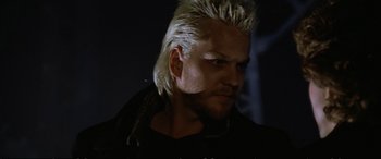 Movie still from “The Lost Boys” (1987), directed by Joel Schumacher – A person with a mohawk hair style; Close Up shot, Low angle