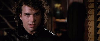Movie still from “The Lost Boys” (1987), directed by Joel Schumacher – A person wearing a leather jacket; Close Up shot, Over the shoulder angle