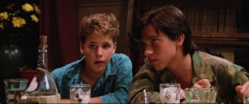 Movie still from “The Lost Boys” (1987), directed by Joel Schumacher – A couple of young men sitting next to each other; Close Up shot, Low angle