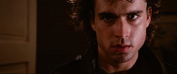 Movie still from “The Lost Boys” (1987), directed by Joel Schumacher – A person wearing a leather jacket; Close Up shot, Low angle