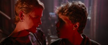 Movie still from “The Lost Boys” (1987), directed by Joel Schumacher – A man and a woman face to face in a room; Close Up shot, Over the shoulder angle