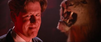 Movie still from “The Lost Boys” (1987), directed by Joel Schumacher – A man's face with a tiger in the background; Close Up shot, Low angle