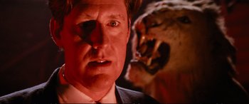 Movie still from “The Lost Boys” (1987), directed by Joel Schumacher – A man's face with a tiger in the background; Close Up shot, Low angle