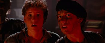 Movie still from “The Lost Boys” (1987), directed by Joel Schumacher – A couple of men standing next to each other; Close Up shot, Low angle