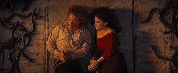 Movie still from “The Lost City” (2022), directed by Aaron Nee – A man and a woman tied to the ground; Medium shot, Overhead angle