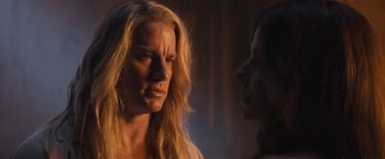 Movie still from “The Lost City” (2022), directed by Aaron Nee – A woman with long blonde hair looking at another woman with long blonde hair; Close Up shot, Over the shoulder angle