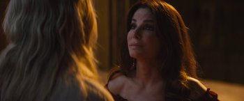 Movie still from “The Lost City” (2022), directed by Aaron Nee – A woman looking at a woman in the mirror; Close Up shot, Over the shoulder angle