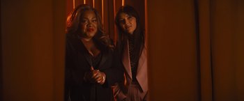 Movie still from “The Lost City” (2022), directed by Aaron Nee – Two women standing next to each other in a room; Medium shot, Over the shoulder angle