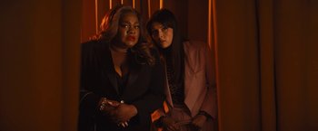 Movie still from “The Lost City” (2022), directed by Aaron Nee – Two women are standing next to each other in a room; Medium shot, Low angle