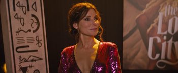 Movie still from “The Lost City” (2022), directed by Aaron Nee – A woman in a red dress is looking up; Close Up shot, Over the shoulder angle